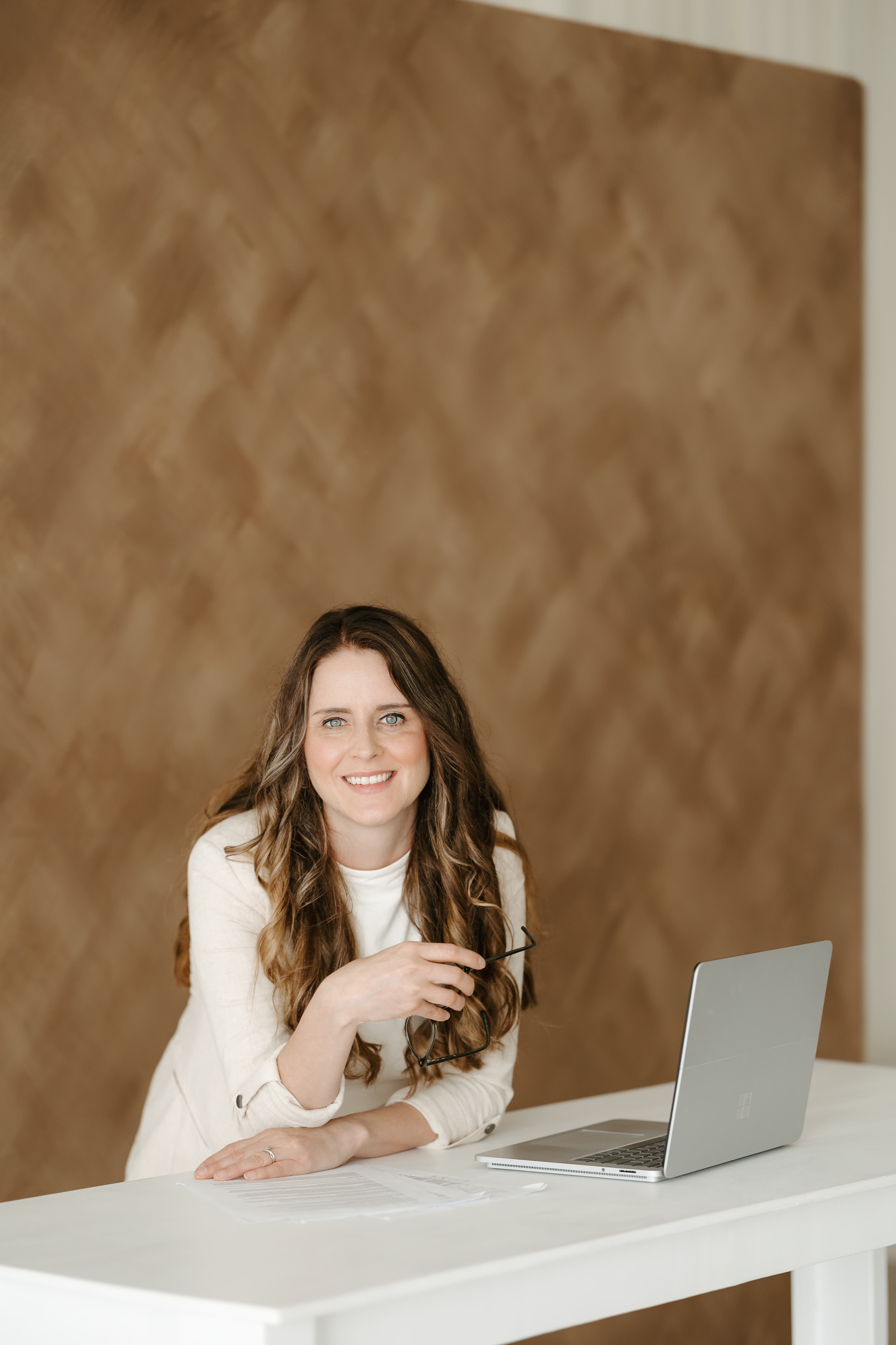 Ashley Schmucker smiling at her desk