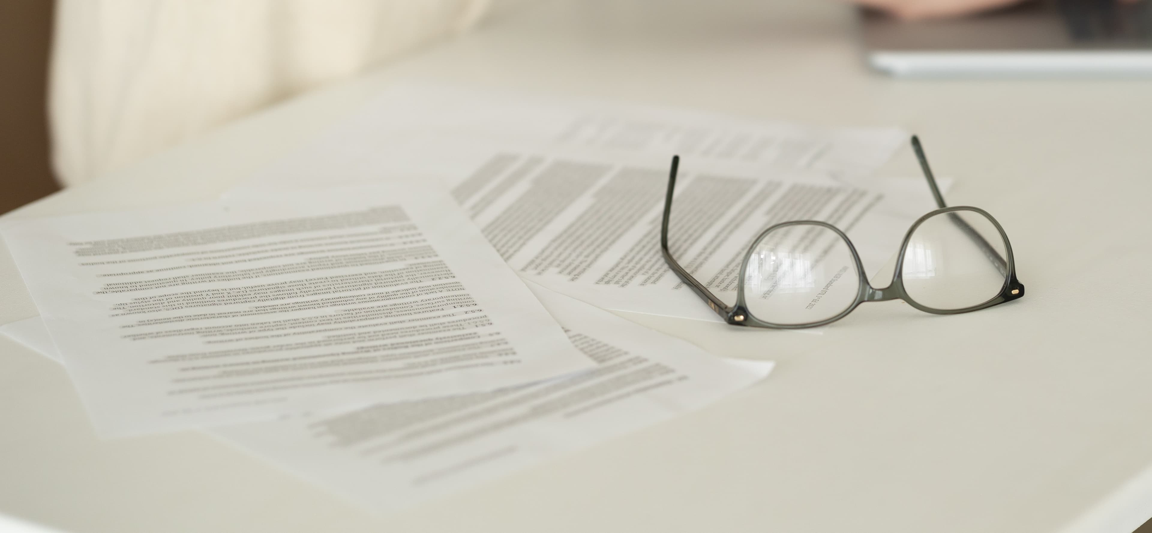 Legal documents and reading glasses on a desk